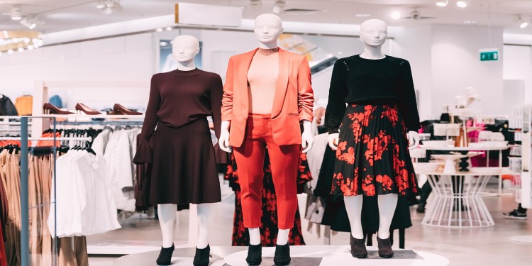 Three mannequins in a clothing shop